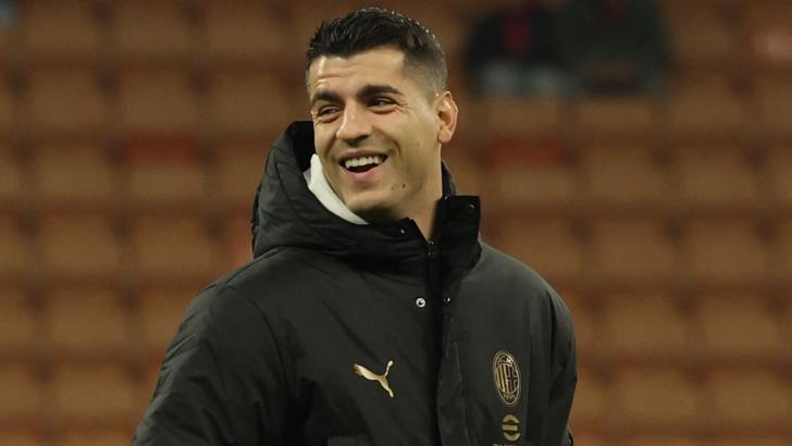 Milan striker Alvaro Morata smiles in his trauning gear on the pitch ahead of a game